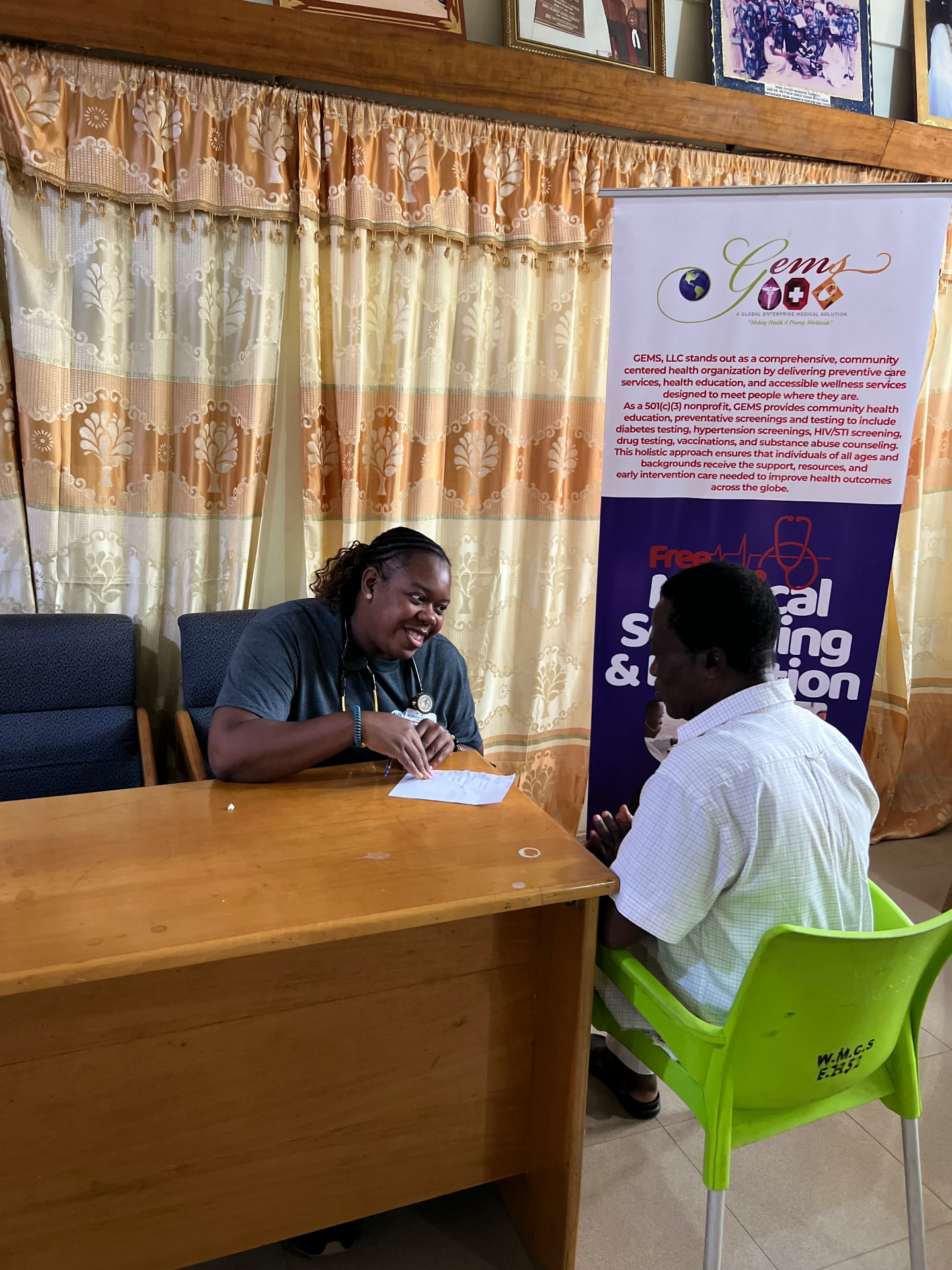 A health professional consulting with a community member during the Ghana medical screening event