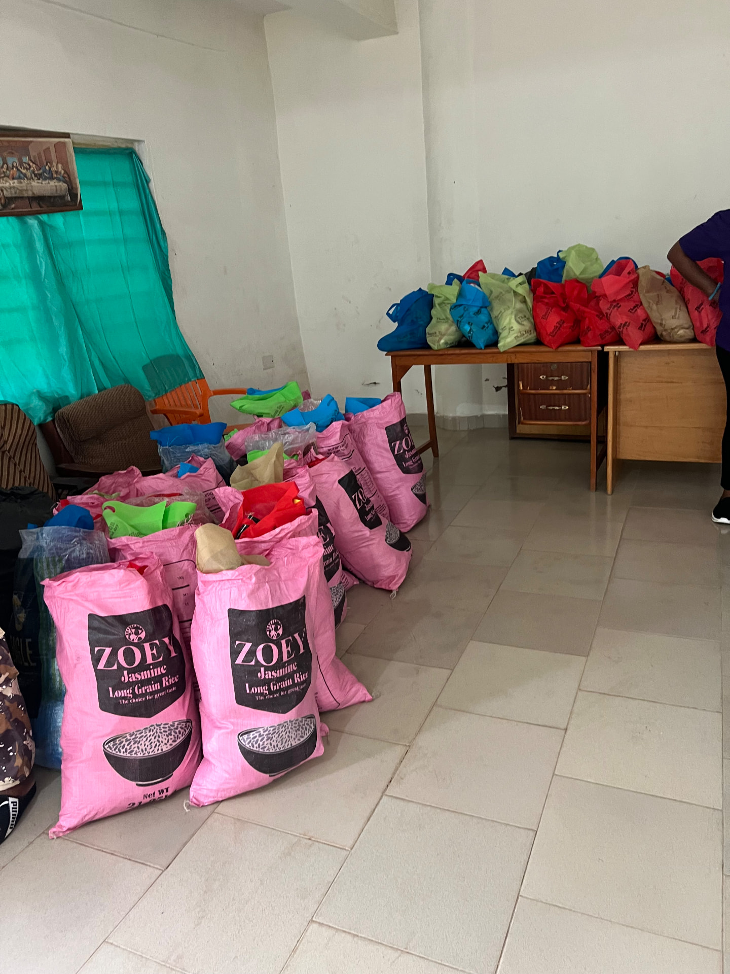 Donated food and supply bags staged for care package assembly at the Ghana outreach site